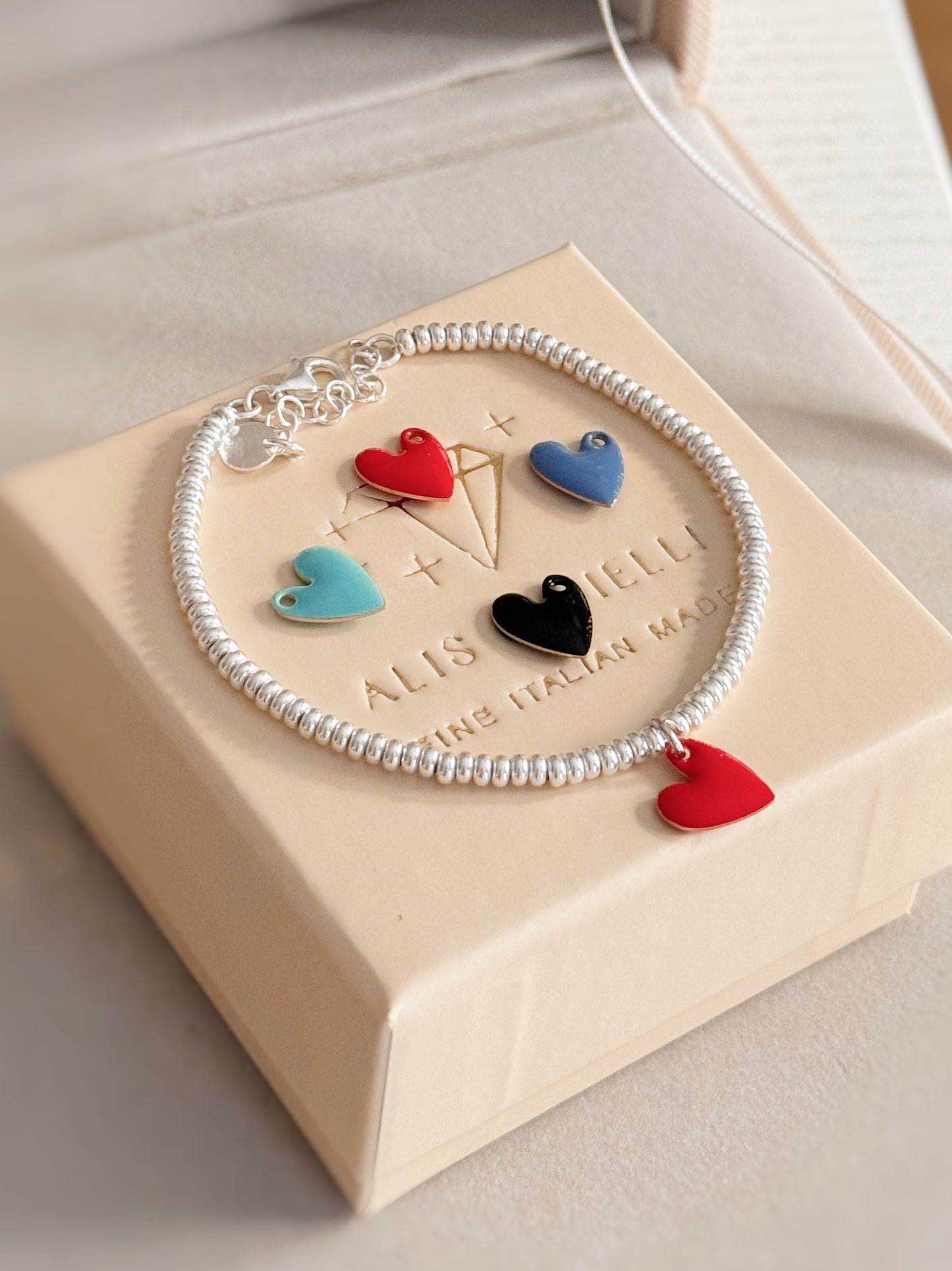 Bracciale rondelle e cuore smaltato